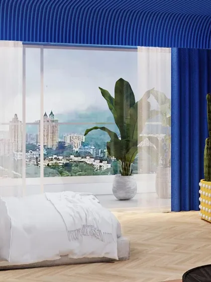 A view of the lounge area, with the city skyline visible through the large windows, creating a contrast between the dreamy interior and the urban exterior.
