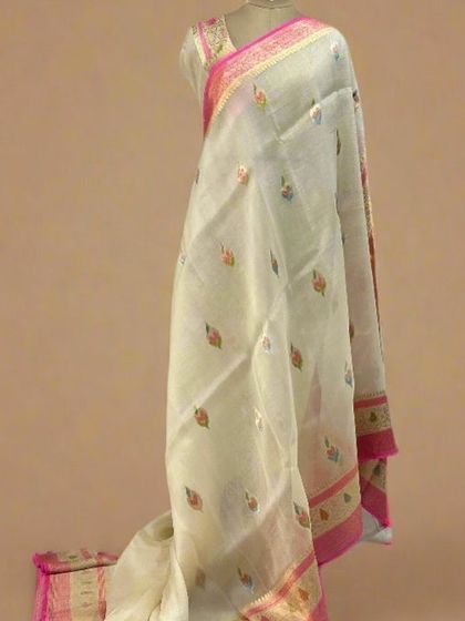 A pure Kora organza saree in a lovely off-white with colorful Meenakari butis and a pink border.