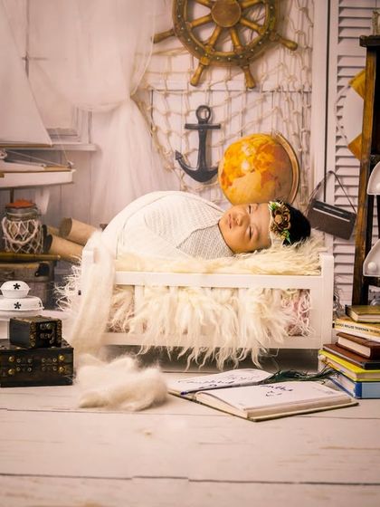 A full view of our popular sailor-themed newborn setup. The scene is complete with a lantern, globe, and vintage books, creating a rich and imaginative backdrop for your little explorer.