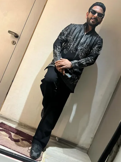 A sleek, black-on-black look for a Dussehra celebration. The silver embroidered kurta adds a touch of festive sparkle to the modern silhouette.