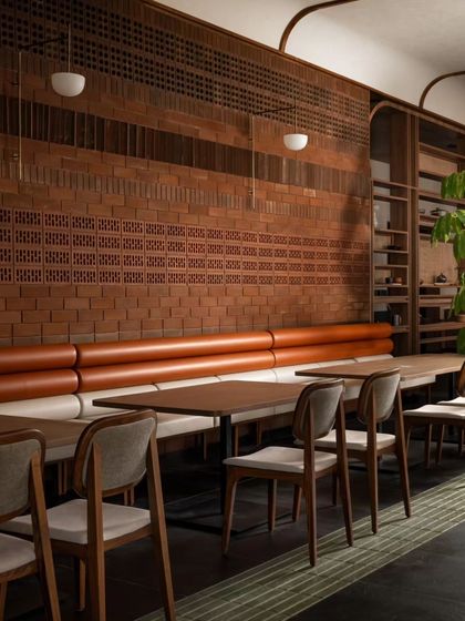 The long line of tables against the brick wall provides ample seating. The simple, clean lines of the tables and chairs ensure the focus remains on the food and the company.