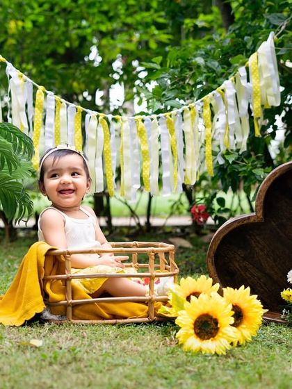 A joyful laugh from a basket in a sunflower patch. Outdoor settings allow for beautiful, naturally lit portraits that feel full of life.