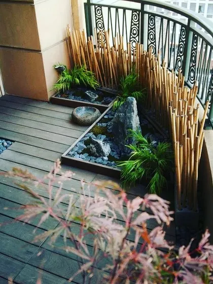 This is a Japanese-inspired Zen garden I created on a curved balcony. I used a bamboo screen for privacy, dark wooden decking, and carefully placed rocks and plants to evoke a sense of calm and simplicity.