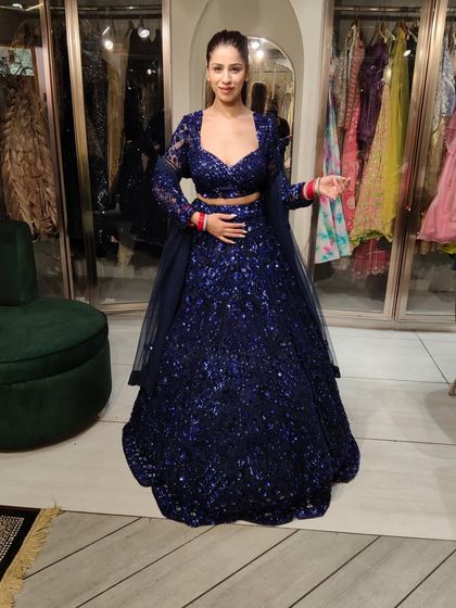 A client looking absolutely stunning in a royal blue sequin lehenga. The full-sleeve blouse and matching dupatta complete this glamorous look.