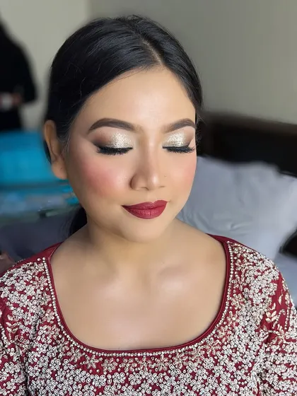 My gorgeous client Ruqaiya, ready for her event. We did a classic silver glitter eye with a sharp wing and a bold berry-red lip, a perfect combination for festive occasions.