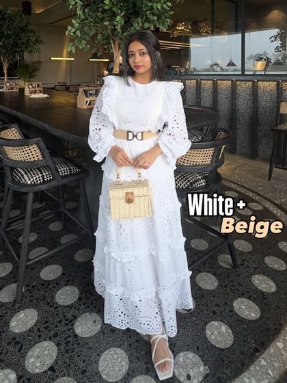 An elegant and clean summer color combination: white and beige. This all-white lace dress is beautifully complemented by a beige belt and a straw bag, creating a sophisticated 'old money' aesthetic.