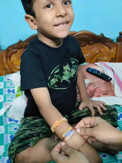 A sweet moment of a sister tying one of our custom Rakhis on her brother's wrist.