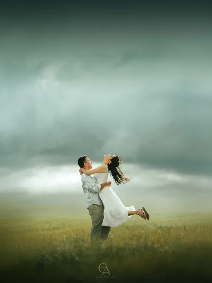 A moment of pure, unscripted joy. I encourage couples to be themselves, and this joyful lift against a dramatic, cloudy sky showcases the energy and connection that make for unforgettable pre-wedding photographs.