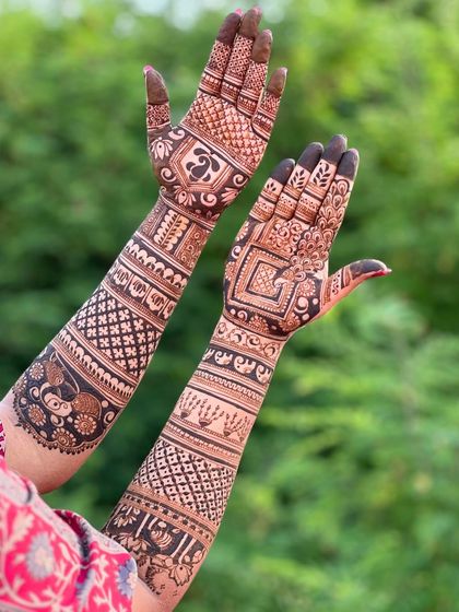 A view of the back of the hands for the same bridal design, showing the continuation of the intricate patterns.