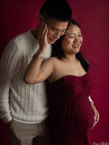 A gentle touch and a shared smile. This image captures the sweet, unspoken communication between a couple as they look forward to meeting their baby.
