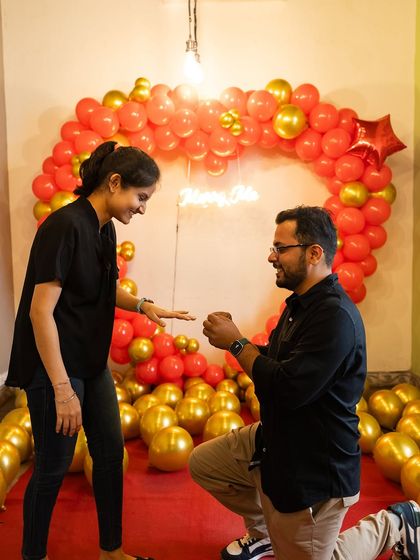 That perfect "Yes!" moment. We help you create the most romantic setting for your proposal, like this beautiful heart-shaped balloon arch with a 'Marry Me' neon sign, ensuring the moment is as special as your love story.