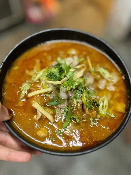 A bowl of our hearty Nalli Nihari, showcasing the tender mutton pieces and the rich, flavorful broth. It's a comforting dish that warms the soul.