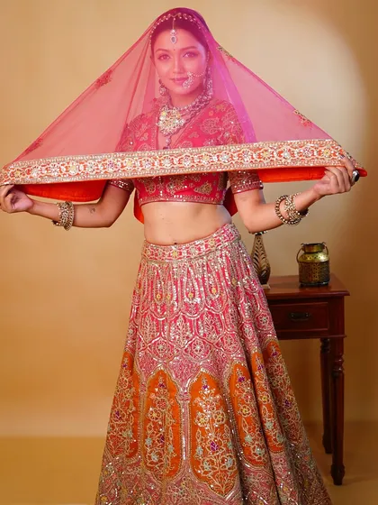 The joy of a bride. This shot shows the full 'Zehra' look with the veil, capturing a moment of happiness and timeless beauty.