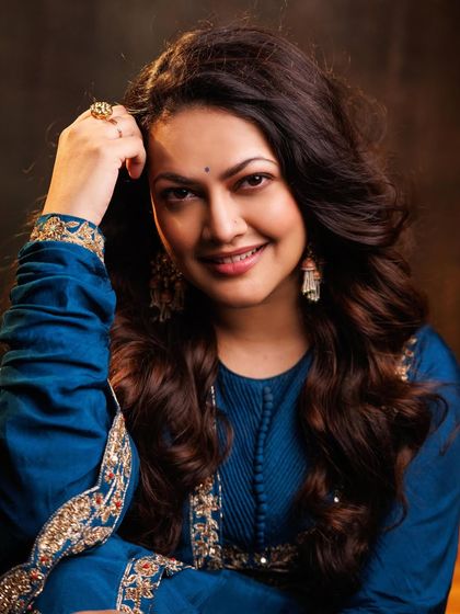 The soft lighting highlights the beautiful smile of Priyanka Barve and the exquisite jewelry chosen to complement her embroidered Anarkali.