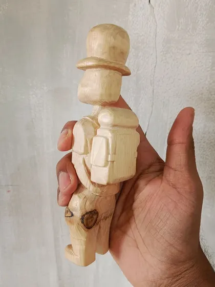 A duplicate of 128, this little traveler was carved from a chip of a tree found lying in the grass. We cleaned him up and gave him a new story.