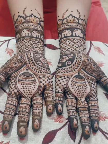 This design features a mix of everything I love: traditional elephant motifs, intricate check patterns, and delicate details on the fingers.