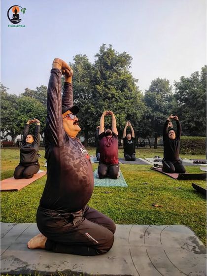 Students practice a variation of Ustrasana (Camel Pose) during a weekend outdoor session.