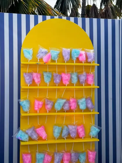 A fun and colorful cotton candy wall, designed as a sweet treat station for the Uttarayan festival. The bright yellow stand and multi-colored candy added a playful touch to the coastal-themed decor.
