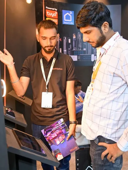 Here, a member of my team is explaining the features of our central control panel to an interested visitor at the expo. I believe in hands-on demonstrations to show the true power of our technology.