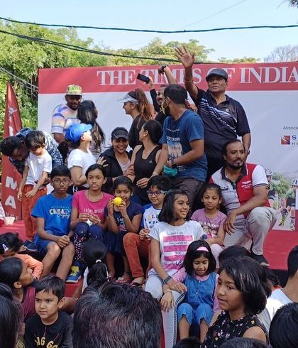 We manage interactive and family-friendly public events. This photo captures the fun at a community gathering we organized, complete with a stage for announcements and activities for all ages.