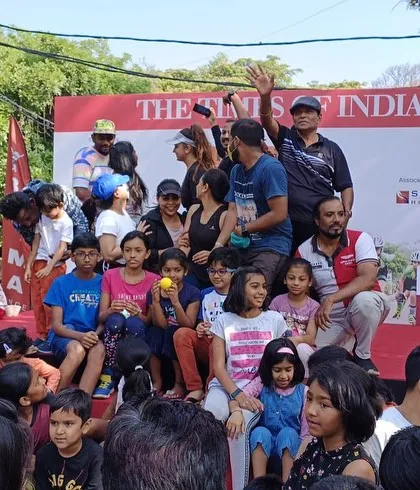 We manage interactive and family-friendly public events. This photo captures the fun at a community gathering we organized, complete with a stage for announcements and activities for all ages.