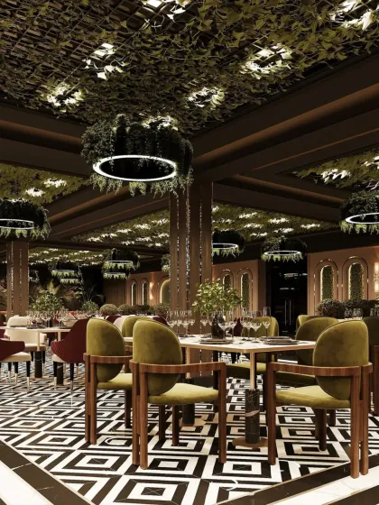 This view highlights the interplay of textures and patterns, from the geometric floor to the dense foliage on the ceiling. The olive green and deep red chairs add sophisticated pops of color to the restaurant interior.