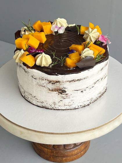 For those who love a bold and nutty cake, I created the Chocolate Hazelnut Naked Cake. It has a decadent chocolate sponge, dark chocolate ganache, a layer of Nutella, and is topped with roasted hazelnuts and almonds for a wonderful crunch.