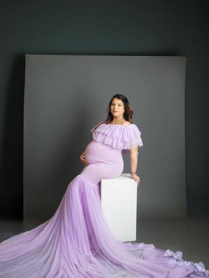 This portrait in a stunning lavender gown is modern and chic. The clean lines of the white block and grey backdrop put all the focus on the beautiful mom-to-be and her flowing dress.