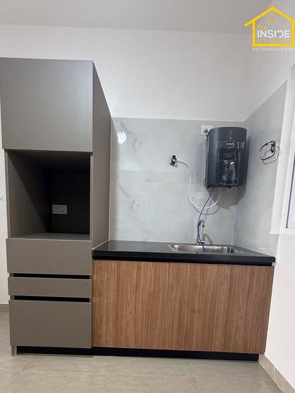 We also design dedicated utility areas to keep your home organized. This unit features a space for the water purifier and additional storage, seamlessly integrated with the main kitchen design.