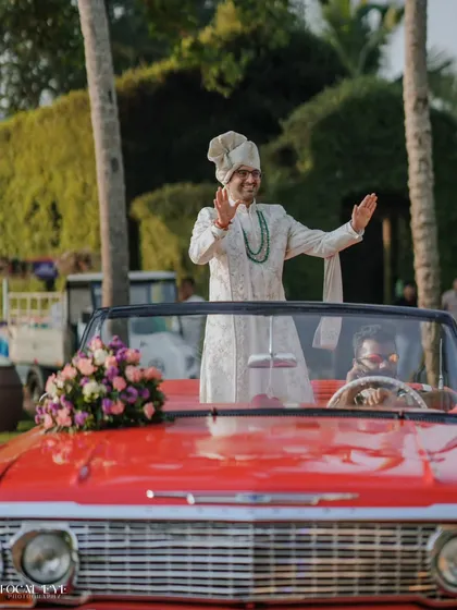 The groom's grand entrance in a classic red convertible. We capture the style, personality, and excitement of the Baraat, ensuring the groom's story is told with flair.