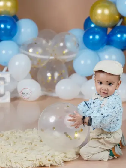 Playing with a clear confetti balloon, this shot adds a touch of sparkle and fun to the first birthday portraits.