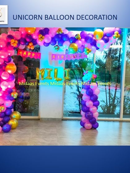 This unicorn balloon arch uses a vibrant mix of purple, pink, and orange. It creates a stunning entrance or backdrop for any party, especially when paired with a personalized name banner.