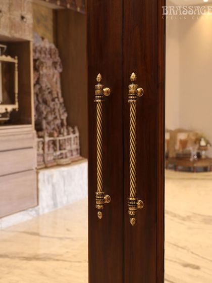 The Chelsea Door Pulls are seen here framing a view into a space with traditional Indian art, reinforcing the heritage-inspired aesthetic of the hardware.