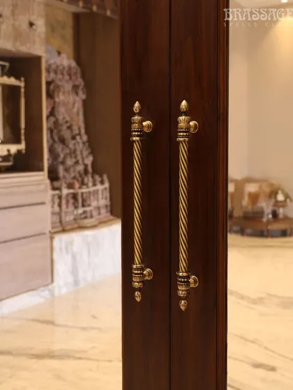 The Chelsea Door Pulls are seen here framing a view into a space with traditional Indian art, reinforcing the heritage-inspired aesthetic of the hardware.