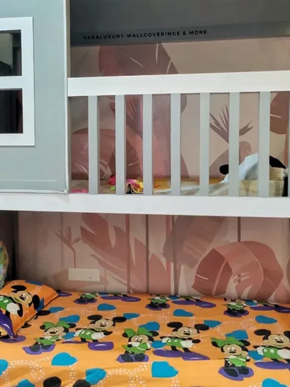 For this bunk bed setup, I installed a subtle pink tropical leaf wallpaper. It adds a touch of fun and color to the sleeping nook, making it a cozy and personalized space.