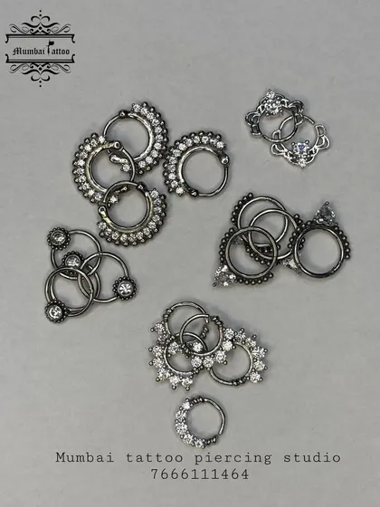 We stock a variety of septum jewelry, including these intricate clickers and rings. Notice the detailed metalwork and embedded crystals, designed to be both secure and eye-catching.