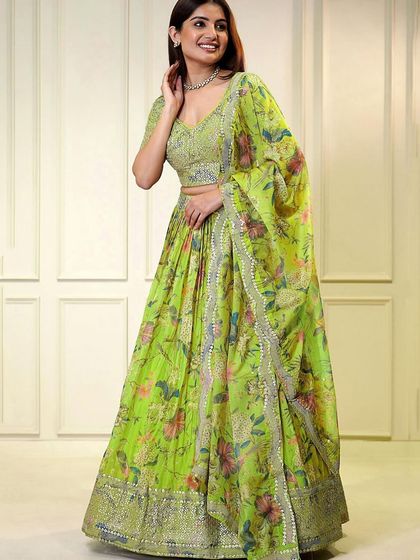 This neon green lehenga is pure energy. The floral organza skirt paired with a sequined blouse makes it a fresh and modern choice for any function.