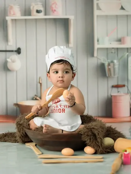A wider view of our fully equipped mini-kitchen set for a chef-themed baby shoot. We create a complete environment to make the theme feel authentic and immersive.