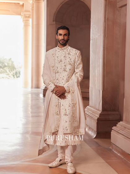 A closer look at the hand-embroidery details on this ivory sherwani. Each stitch is placed with intention to create a texture that is rich, luxurious, and tells a story of its own.