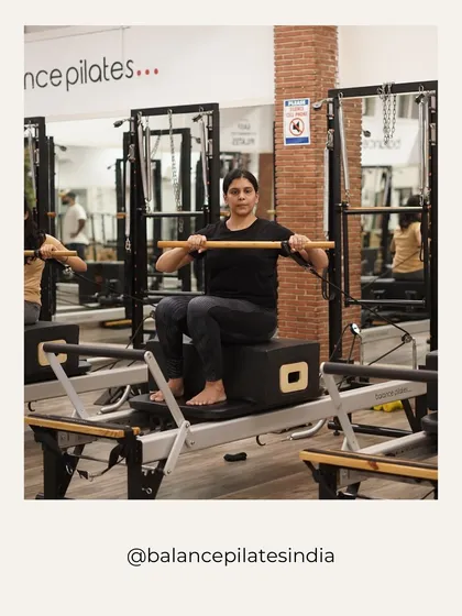 A client is focused and working hard on the reformer with a short box. This is a real, unposed moment of progress in the studio.