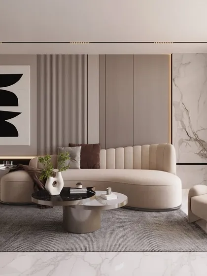Soft sophistication defines this living room, where a curved sofa and armchairs create a gentle, welcoming flow. The minimalist artwork and subtle wall paneling add to the serene and elevated atmosphere.
