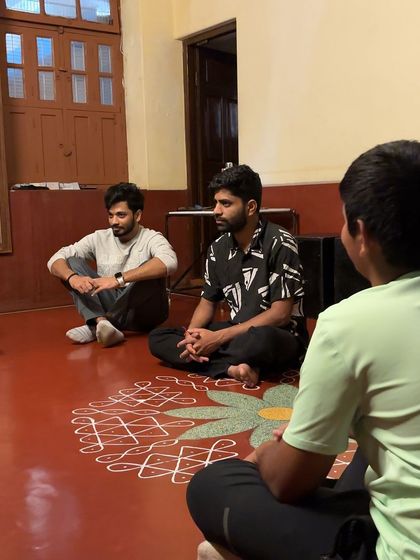 Participants listen intently during a group session. Peer learning and active listening are skills we cultivate alongside acting techniques.