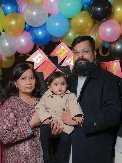 A formal family group photograph from Vasuki's first birthday party. I can organize and capture posed group shots to ensure you have a perfect record of everyone who attended.