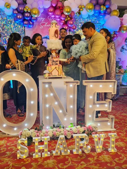 The birthday girl and her family cutting the magical fairy cake.