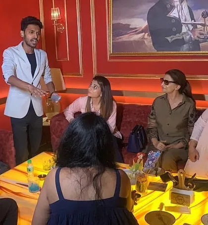 Engaging directly with guests during a close-up performance at a private event. This interactive style ensures the magic feels personal and real.