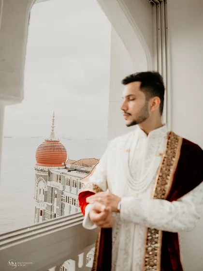 A groom's portrait should reflect his personality and the significance of the day. Here, at the iconic Taj Mahal Palace, Noman's portrait captures a sense of royal elegance and quiet contemplation.