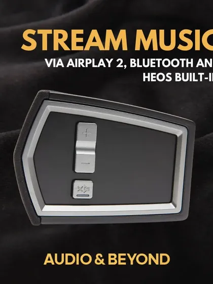 This Denon soundbar system allows you to stream music effortlessly via AirPlay 2, Bluetooth, and its built-in HEOS technology. The close-up shows the simple control interface for volume and source selection.