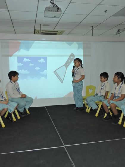 Students participate in a visual spelling round, connecting images with words. This multi-sensory approach to language helps reinforce learning and makes it more engaging for everyone.