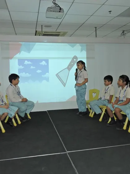Students participate in a visual spelling round, connecting images with words. This multi-sensory approach to language helps reinforce learning and makes it more engaging for everyone.