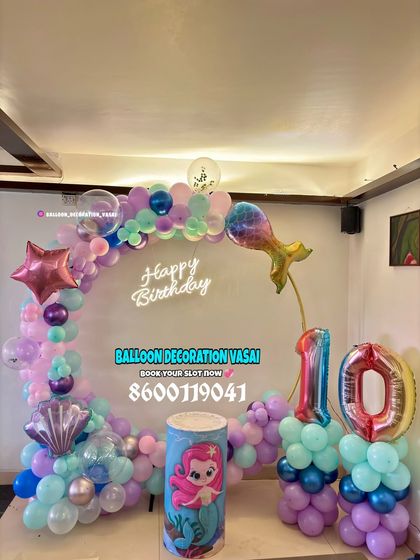 A mermaid theme for a 10th birthday. This ring setup features pastel balloons, mermaid tail and seashell foil balloons, and a themed cake plinth.